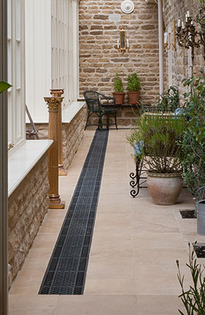 Floor Grilles Provide Heating In This Narrow Hall