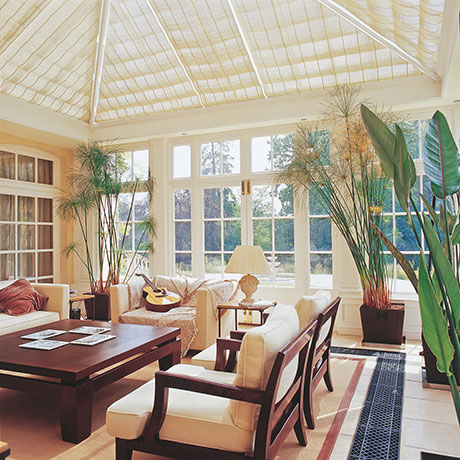 Floor grilles set within a tiled floor in a conservatory.